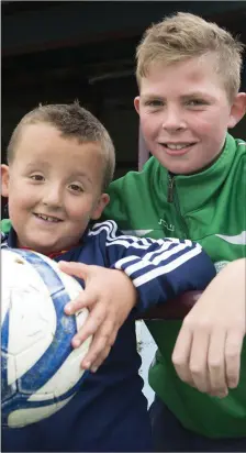  ??  ?? Jake Tuomey and Tariq Bradley at the Johnny Hughes Memorial match cup at united park