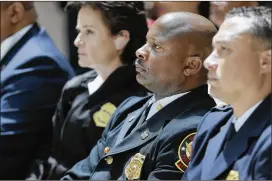  ?? BOB ANDRES PHOTOS / BANDRES@AJC.COM ?? Interim Fire Chief Randall B. Slaughter (center) was among the 26 senior-level city employees who Mayor Keisha Lance Bottoms asked to submit their resignatio­n on Tuesday.