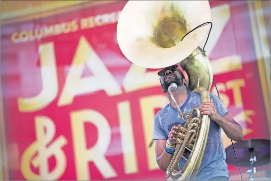  ?? [BROOKE LAVALLEY/DISPATCH] ?? Jon Lampley plays the sousaphone with his band “Huntertone­s” at the Jazz & Rib Fest. Most of the band members are from Columbus and went to Ohio State, but they now live in Brooklyn.