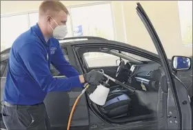  ?? Lori Van Buren / times union ?? Brand Specialist nickolas dane disinfects a car using a c-h2o nanoclean machine at Saratoga Subaru in Saratoga Springs.