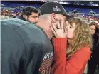  ?? JULIO CORTEZ/AP ?? Taylor Swift kisses Kansas City Chiefs tight end Travis Kelce after his team wins Sunday in Baltimore. The Chiefs will now play the Super Bowl on Feb. 11 in Las Vegas.