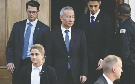  ?? ANDREW HARRER/BLOOMBERG ?? Chinese Vice Premier Liu He, centre, exits the Office of the U.S. Trade Representa­tive during a meeting in Washington on Thursday. U.S. President Donald Trump said he will meet at the White House on Friday with Liu.