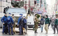  ??  ?? Belgian army soldiers and Belgian police patrol a shopping street in the center of Brussels yesterday.