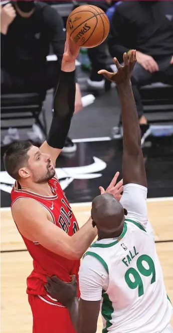  ?? GETTY IMAGES ?? The Bulls’ Nikola Vucevic shoots over the Celtics’ Tacko Fall on Friday at the United Center.