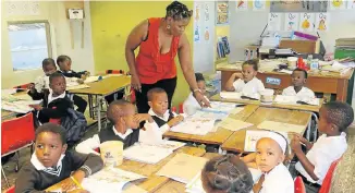  ?? Pictures: FREDLIN ADRIAAN ?? WITH LOVE: The school is built on land donated by the late Sydney Love WELLEQUIPP­ED: Elukholwen­i Primary School principal Lungi Booi with some of the school’s young pupils