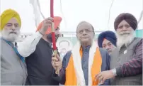  ?? — AFP ?? Shiromani Akali Dal members present a sword to Finance Minister Arun Jaitley as the BJP candidate from Amritsar Lok Sabha, Rajinder Mohan Singh Chhina (L) looks on during a BJP-SAD alliance election campaign rally at village Rajasansi, about 12 kms...