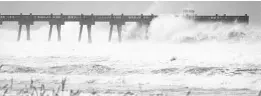  ?? STEPHEN MORTON/GETTY IMAGES FILE ?? Pensacola Beach’s pier takes a pounding in September 2004, as Hurricane Ivan lashes the Panhandle. Hurricanes Charley, Frances and Jeanne tore up Central Florida that year.