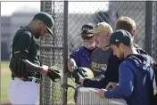  ?? DARRON CUMMINGS — THE ASSOCIATED PRESS ?? A’s pitcher Sean Manaea signs autographs at camp in Mesa, Ariz. He made his Cactus League debut Monday.