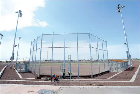  ?? Buy these photos at YumaSun.com PHOTOS BY RANDY HOEFT/YUMA SUN ?? A CITY OF YUMA CREW INSTALLS A PUBLIC ADDRESS SYSTEM at one of the six fields that make up the Pacific Avenue Athletic Complex.