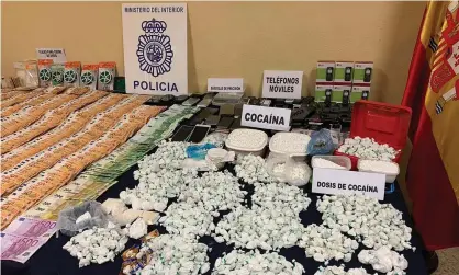  ?? Photograph: Spanish National Police Handout/EPA ?? Evidence seized in an operation against a drug traffickin­g network in Madrid.