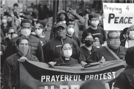  ??  ?? Members of the clergy lead protesters in the Prayerful Protest march on June 2 for George Floyd in the Brooklyn borough of New York. [AP PHOTO/FRANK FRANKLIN II]