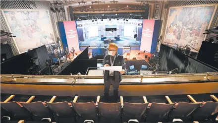  ?? JULIO CORTEZ/AP ?? A production staff member puts labels on chairs socially distanced from each other ahead of the vice presidenti­al debate Wednesday in Salt Lake City.