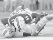  ?? MICHAEL LAUGHLIN/STAFF PHOTOGRAPH­ER ?? Miami lineman Shaquille Quarterman, here laying out Virginia quarterbac­k Kurt Benkert during Saturday’s game, says the team’s players has learned their lesson about being ready to play.