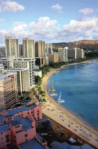  ?? Photo: iStock ?? TIDE OF TOURISTS: The famous Waikiki Beach, on Oahu, surrounded by high-rise buildings. Its modern vibe may suit some tourists but, if crowds aren’t your thing, opt for another Hawaiian island.