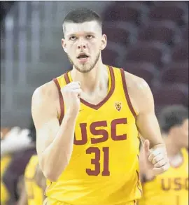  ?? Kyusung Gong Associated Press ?? “WE WANT HIM to go in there, play defense, be loud, be energetic and offensive rebound,” USC point guard Jordan McLaughlin says of Nick Rakocevic, above.