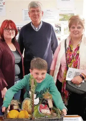 ??  ?? Wholesome produce Pictured are some of the Ericht Allotment Associatio­n members, from left, Cheryl Brant, Brian Smith and Susan Duncan, with seven-year-old James Duncan