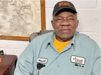  ?? (Marvin Richards/News-Times) ?? Bud Miles sits in the Department of Public Works office, proudly wearing his “Pleasant” name badge.