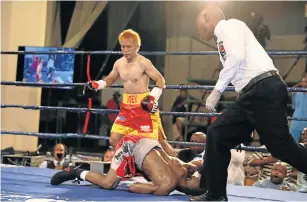  ?? Picture: ALAN EASON ?? TRULY DECKED: Simpiwe Konkco hits the canvas hard after being knocked down by Filipino challenger Joey Canoy at the Orient Theatre on Sunday.