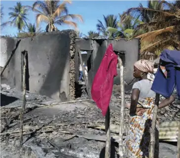  ??  ?? A woman stands among the ruins of her destroyed home in Palma, Cabo Delgado.