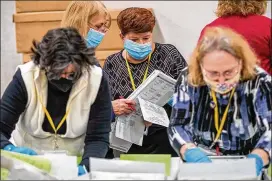  ?? AJC 2020 ?? The hard work that election workers throughout Georgia, such as these in Cobb County, did in the tumultuous 2020 voting is still coming under attack from politician­s whose main purpose seems to be acting on Donald Trump’s “stolen” narrative.