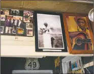  ??  ?? Portraits of Henry Stuckey, the originator of the Bentonia blues, (second from right) and area resident and bluesman Jack Owens, hang high on the wall at the Blue Front Cafe Bentonia, Miss.