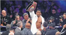  ??  ?? Anthony Joshua of Great Britain celebrates victory over Joseph Parker of New Zealand after their heavyweigh­t unificatio­n bout at Principali­ty Stadium in Cardiff.