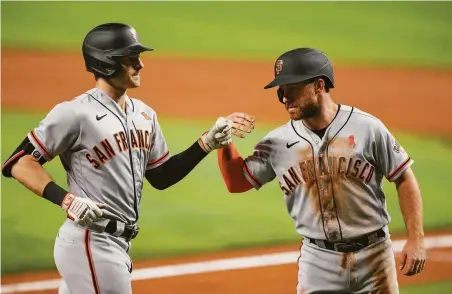  ?? Eric Espada / Getty Images ?? Mike Yastrzemki (left) is congratula­ted by Donovan Walton after Yastrzemki hit a home run in the second inning.