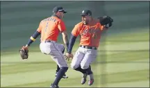  ?? ASHLEY LANDIS — THE ASSOCIATED PRESS ?? Houston’s Carlos Correa, left, and George Springer celebrate after beating the Athletics in Game 2 Tuesday.