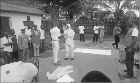  ?? KARSTEN VOIGT/INTERNATIO­NAL FEDERATION OF RED CROSS AND RED CRESCENT SOCIETIES VIA AP ?? Members of a Red Cross team don protective clothing Monday before heading out to look for suspected victims of Ebola, in Mbandaka, Congo. Congo’s Ebola outbreak has spread to Mbandaka, a crossroads city of more than 1 million people, in a troubling...