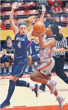  ?? JIM THOMPSON/JOURNAL ?? UNM’s Madi Washington, right, takes to the air as she heads toward the basket. Defending is Nevada’s Halie Bergman.