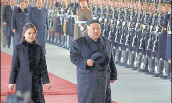  ?? AP ?? North Korean leader Kim Jong Un walks with his wife Ri Sol Ju at Pyongyang Station before leaving for China. Kim arrived in Beijing on Tuesday for his fourth summit with Chinese President Xi Jinping.