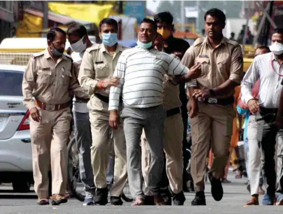  ?? (EPA) ?? Vikas Dubey after handing himself in to Madhya Pradesh police on Thursday. Less than 24 hours later he was dead