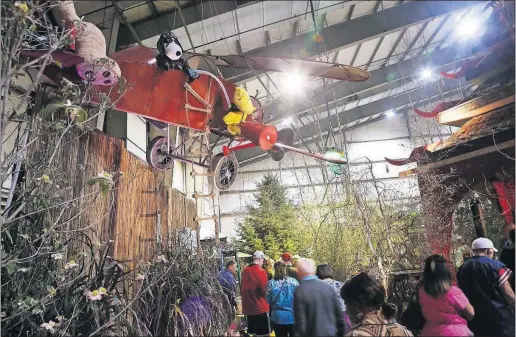  ?? [BROOKE LAVALLEY/DISPATCH] ?? Visitors check out a Chinese garden called “Kung Fu Teddy” on Saturday during the Dispatch Home and Garden Show at the Ohio Expo Center. This year’s show features gardens from 12 countries and cultures. The show runs through next Sunday. Hours are 10...