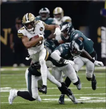  ?? BILL FEIG – THE ASSOCIATED PRESS ?? New Orleans Saints wide receiver Tre’Quan Smith runs with the football while Eagles Malcolm Jenkins (27) and Rasul Douglas (32) stumble behind Sunday.