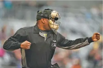 ?? AP PHOTO/ABBIE PARR ?? An umpire signals for a strikeout after being told a strike call through an earpiece during a minor league baseball game between the St. Paul Saints and the Nashville Sounds on May 5 in St. Paul, Minn.