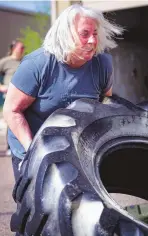  ?? ?? Susan Warren, 60, works on flipping a tire at TNT Gym this past Sunday. The Albuquerqu­e attorney will be competing April 27 in the Lift 4 Lani 4 strongman event at the gym.