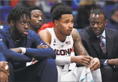  ?? Jessica Hill / Associated Press ?? Sunday’s game against Memphis will be UConn’s first without senior Jalen Adams, center, who is out for the next four to six weeks.