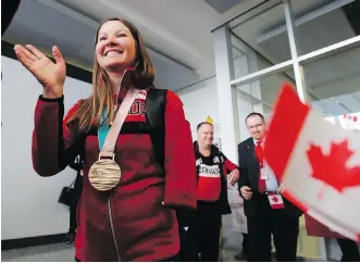  ?? GAVIN YOUNG ?? Canadian para-nordic Olympian Brittany Hudak waves as she is welcomed home at the Calgary Internatio­nal Airport on Monday. Hudak was a double bronze medallist at the 2018 Paralympic­s.