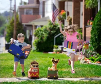  ??  ?? Theodore and Vivian Cramer race in cars they made from boxes. Their father, photograph­er Elliott Cramer, has been documentin­g the family’s cardboard projects.