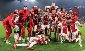  ?? Photograph: BSR Agency/ Getty Images ?? The Ajax players enjoy themselves on Borussia Dortmund’s pitch after qualifying for the Champions League knockout stage with their fourth straight win.