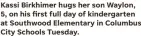  ??  ?? Kassi Birkhimer hugs her son Waylon, 5, on his first full day of kindergart­en at Southwood Elementary in Columbus City Schools Tuesday.