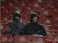  ?? JAY LAPRETE — ASSOCIATED PRESS ?? Fans brave the rain to watch the final minutes of Ohio State against Illinois on Nov. 18, 2017, in Columbus. Ohio State won, 52-14.