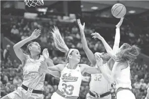  ?? ADAM CAIRNS/COLUMBUS DISPATCH ?? Ohio State forward Cotie Mcmahon (32) reaches for a rebound between Indiana’s Yarden Garzon (12) and Sydney Parrish and Ohio State’s Taylor Thierry.
