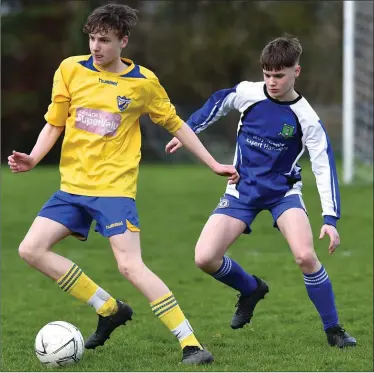  ?? Killorglin’s Keith Evans chased by Christophe­r Palmer, Ballyhar, in thir Kerry Schoolboys Under-16 league in Ballyhar last season ??