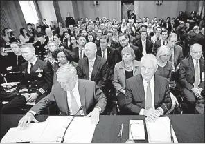  ?? AP/MANUEL BALCE CENETA ?? Defense Secretary James Mattis (front left) and Secretary of State Rex Tillerson prepare their documents during a Senate Foreign Relations Committee hearing on Capitol Hill dealing with the authorizat­ion of military force.