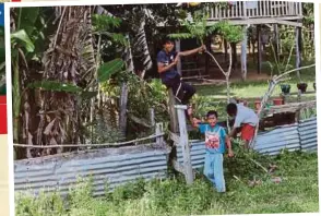  ??  ?? PENDUDUK Kampung Tanjung Batu meneruskan kehidupan mereka.