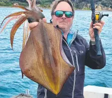  ??  ?? TASTY: Ashley Hallen with an East Coast calamari squid.