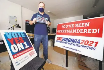  ?? Steve Helber Associated Press ?? BRIAN CANNON, an advocate for redistrict­ing reform, with yard signs and bumper stickers in his office in Richmond, Va. Commission­s with the aim of reducing partisansh­ip have seen their intentions undermined.