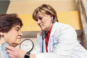  ?? COURTESY OF UNM COLLEGE OF NURSING ?? Nurse Practition­er Sharon Schaaf applies a stethoscop­e to Corina Casias. The UNM College of Nursing’s online MSN program was ranked No. 21 in the latest U.S. News & World Report rankings for 2023.