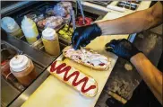 ?? ?? An adaptation of the Elena Ruz sandwich is prepared with medianoche bread, guava marmalade, cream cheese, turkey and bacon at Sanguich de Miami in Miami on Nov. 13. The sandwich, named after Elena Ruz, melds sweet and savory.